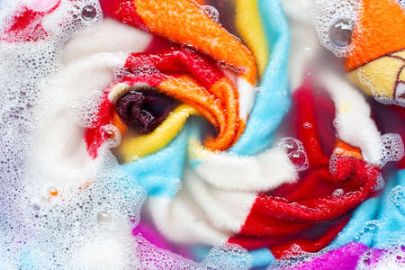 Colorful blanket soak in powder detergent water dissolution, washing  cloth. Laundry conceptの写真素材