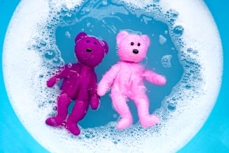 Soak bear toys in laundry detergent water dissolution before washing.  Laundry concept, Top view