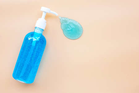 Alcohol hand sanitizer gel in pump bottle on cream color background. Copy spaceの写真素材