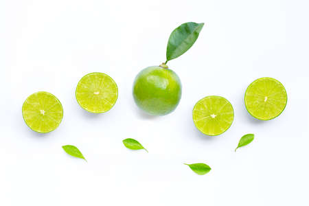 Limes with leaves isolated on white background.の写真素材