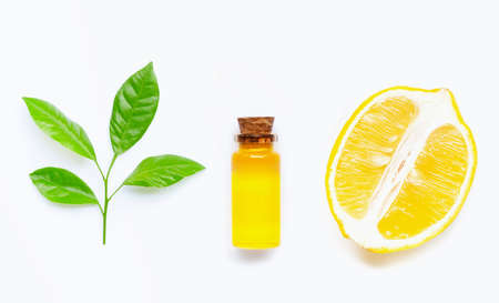 Natural oil with lemon and citrus green leaves on white background. High vitamin C. の写真素材