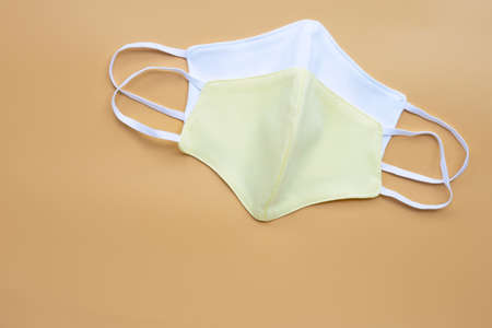 Cloth masks on cream color background. Copy space