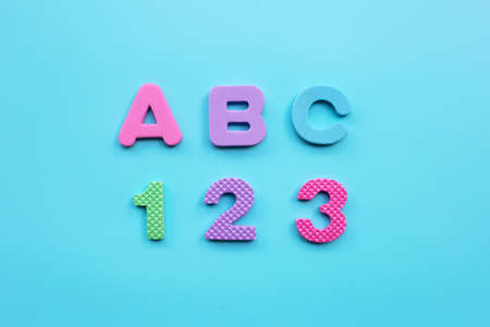 English alphabet and numerals on blue background. Education concept, Copy spaceの写真素材