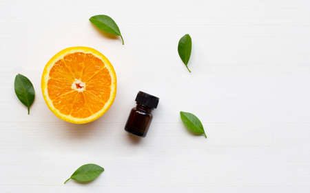 Essential oil with orange fruit on white wooden background. Copy spaceの写真素材