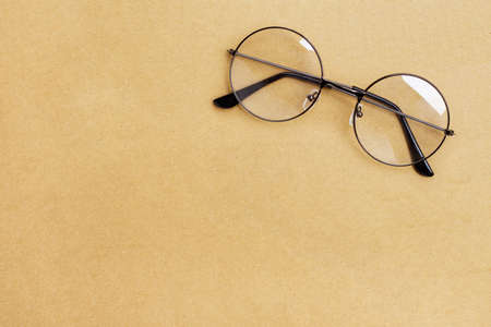 Eye Glasses on brown paper background. Copy spaceの写真素材