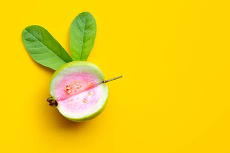 Top view of fresh ripe guava with leaf on yellow background. Copy spaceの写真素材