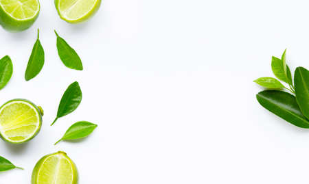 Limes with leaves isolated on white background.の写真素材