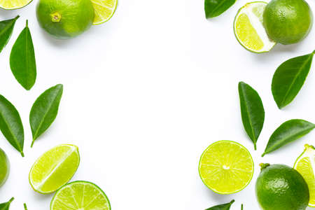 Frame made of fresh limes with green leaves on white background. Copy spaceの写真素材