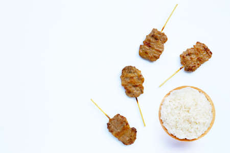 Grilled pork with sticky rice on white background. Copy spaceの写真素材