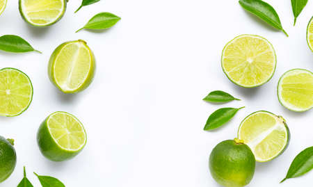Limes with leaves isolated on white background.の写真素材