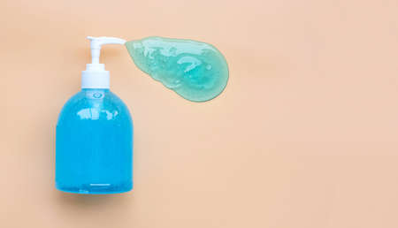 Alcohol hand sanitizer gel in pump bottle on old rose color background. Copy spaceの写真素材