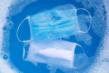 Protective medical mask with cloth mask soak in powder detergent water dissolution before washing....
