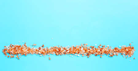 Pink himalayan salt  on blue background. Copy space