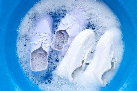 Soak shoes before washing. Cleaning Dirty sneakers.の写真素材