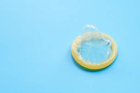 Condom on blue background with copy space. Save sex conceptの写真素材