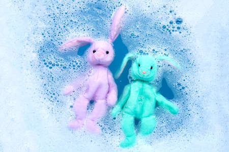 Soak rabbit dolls in laundry detergent water dissolution before washing.  Laundry concept, Top view