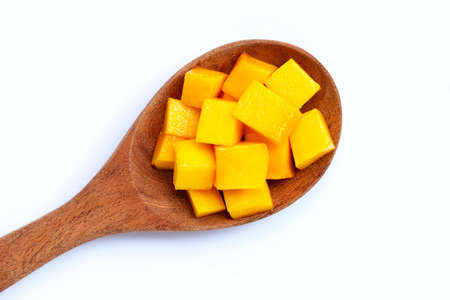 Tropical fruit, Mango cube slices on wooden spoon on white background. の写真素材