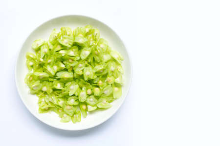 Moringa oleifera seeds in white plate isolated on white background.の写真素材