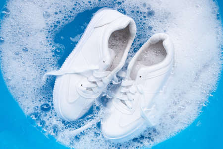 Soak shoes before washing. Cleaning Dirty sneakers.の写真素材