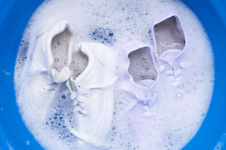 Soak shoes before washing. Cleaning Dirty sneakers.の写真素材