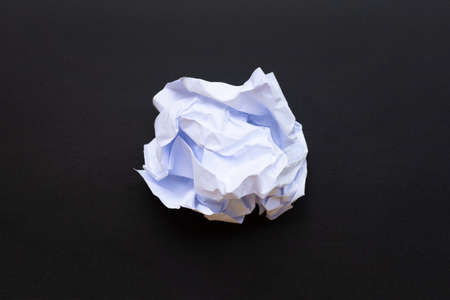 Crumpled white paper ball on black school chalkboard. Top viewの写真素材
