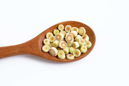 Fresh lemongrass slices on wooden spoon on white background.の写真素材