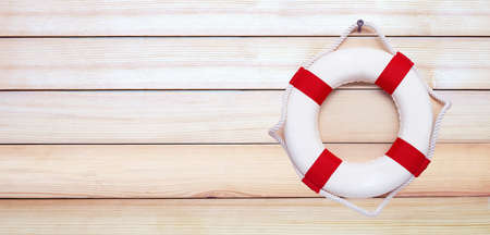 Lifebuoy on wooden background. Copy spaceの写真素材