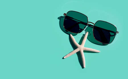 sunglasses with starfish on blue background. Enjoy holiday concept.の写真素材