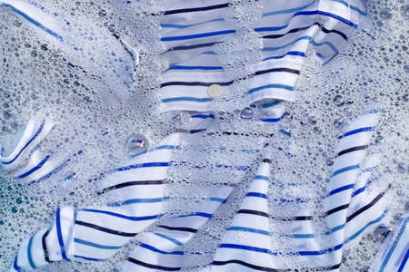 Top view of clothes soak in powder detergent water dissolution. Laundry conceptの写真素材