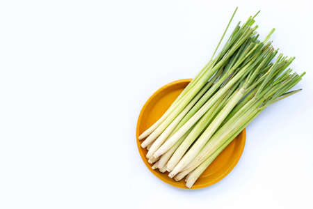 Fresh lemongrass on yellow plate on white background. Copy spaceの写真素材