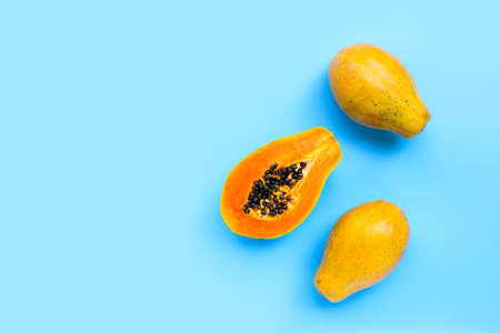 Papaya fruit on blue background. Top viewの写真素材