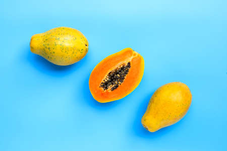 Papaya fruit on blue background. Top view