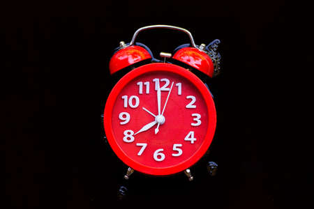 Red alarm clock in black coffee. Top viewの写真素材