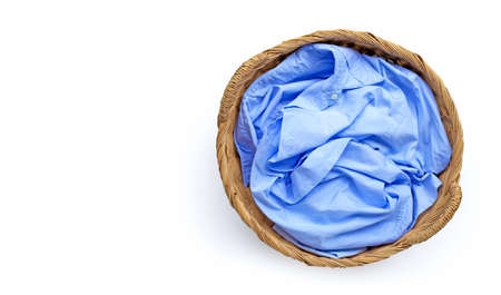 Clothes in laundry basket on white background. Copy spaceの写真素材