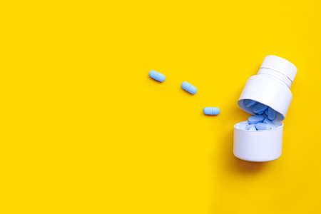 PrEP ( Pre-Exposure Prophylaxis) used to prevent HIV with white plastic medical bottle on yellow background. Copy spaceの写真素材