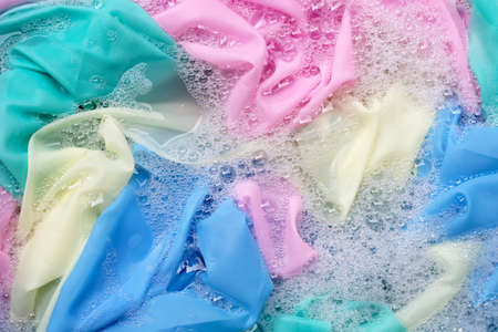 Color clothes soak in powder detergent water dissolution. Laundry conceptの写真素材