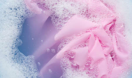 Color clothes soak in powder detergent water dissolution. Laundry conceptの写真素材
