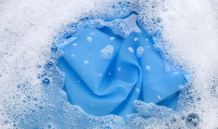 Color clothes soak in powder detergent water dissolution. Laundry conceptの写真素材