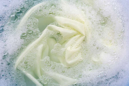 Color clothes soak in powder detergent water dissolution. Laundry conceptの写真素材