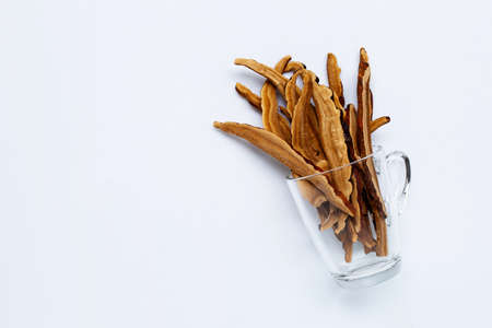 Dried lingzhi mushroom slices with glass on white background. Copy spaceの写真素材
