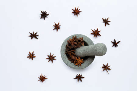 Star anis in  stone mortar with pestle on white background. Top viewの写真素材