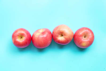 Ripe pink apples on blue background. Top viewの写真素材