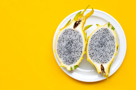 Yellow pitahaya or dragon fruit on yellow background. Copy spaceの写真素材