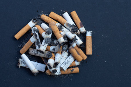 Cigarette butts on dark background.の写真素材