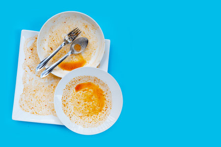 Dirty dishes on blue  background. Top viewの写真素材
