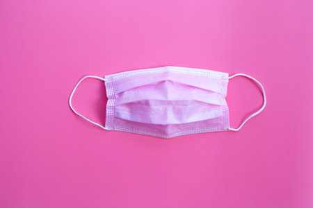 Pink protective medical mask on pinkの写真素材