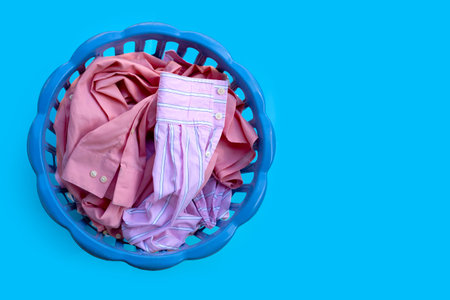 Clothes in a laundry basket on blueの写真素材