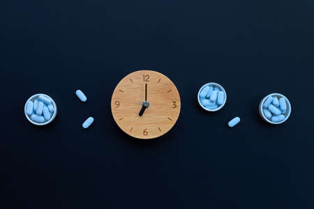 Clock with PrEP ( Pre-Exposure Prophylaxis). used to prevent HIV on dark background. Copy space