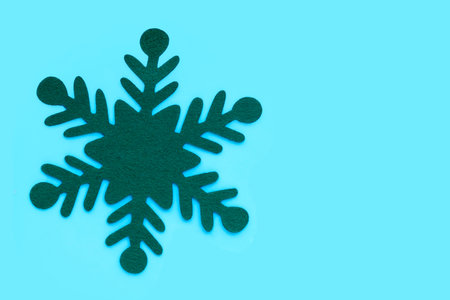 Green christmas snowflake on blue background.の写真素材