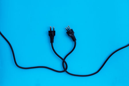 Electric plugs on blue background. Top view